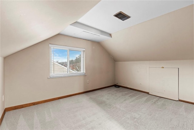 bonus room featuring lofted ceiling and light carpet