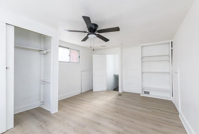 unfurnished bedroom featuring a ceiling fan, visible vents, baseboards, and light wood-style floors