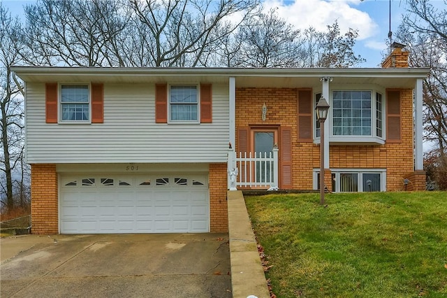 split foyer home with a front yard and a garage