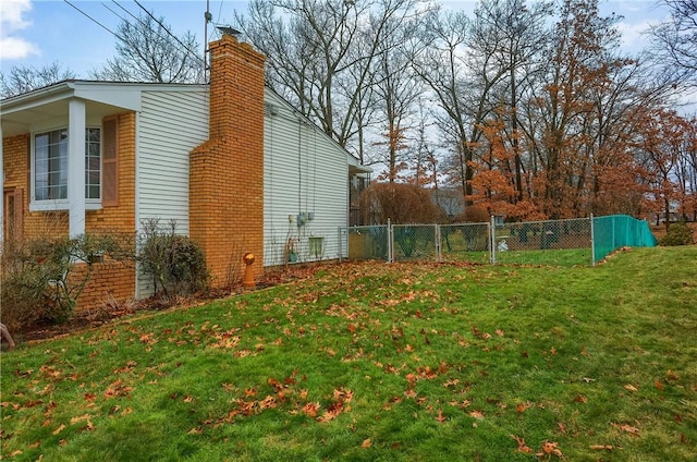 view of side of home featuring a lawn