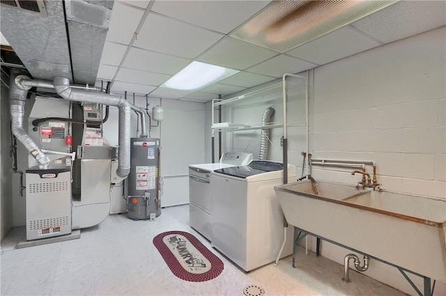 washroom with washer and dryer, heating unit, and gas water heater