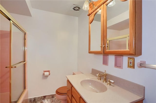 full bathroom featuring vanity, combined bath / shower with glass door, and toilet