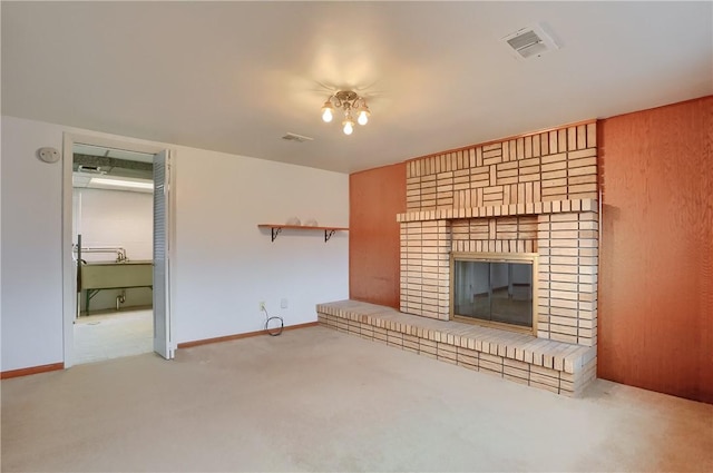 unfurnished living room featuring a fireplace and light carpet