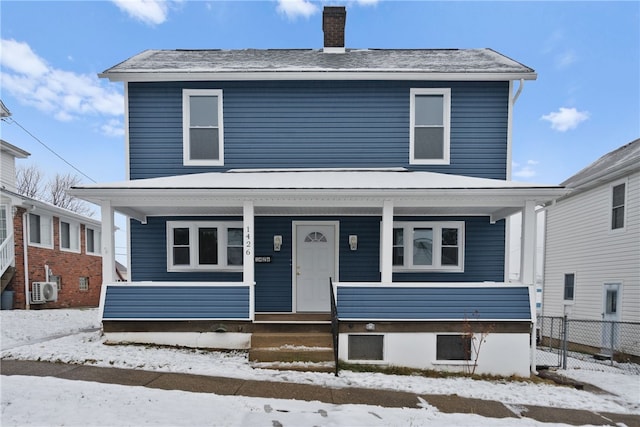 view of property featuring ac unit and a porch