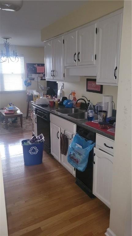 kitchen with a chandelier, wood-type flooring, sink, dishwasher, and white cabinets