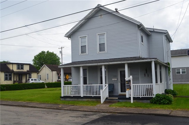 farmhouse with covered porch and a front lawn