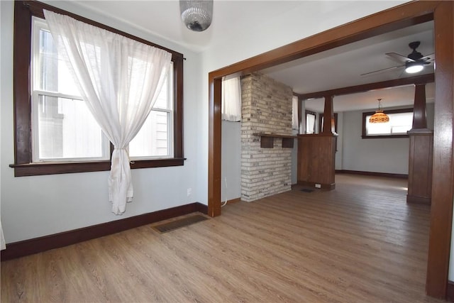 unfurnished living room featuring hardwood / wood-style floors, beamed ceiling, and ceiling fan