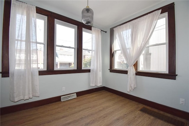 unfurnished room featuring hardwood / wood-style flooring