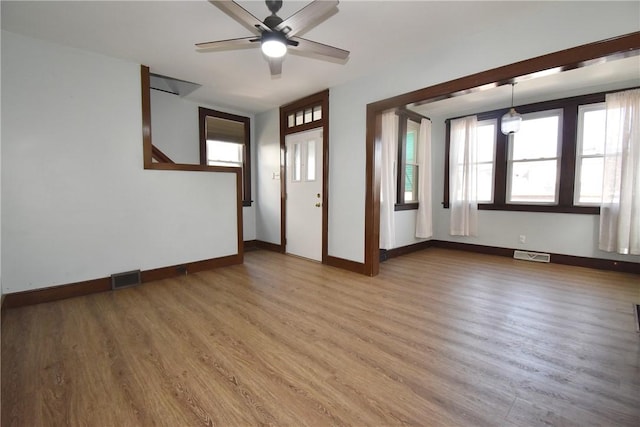 unfurnished room with hardwood / wood-style flooring and ceiling fan