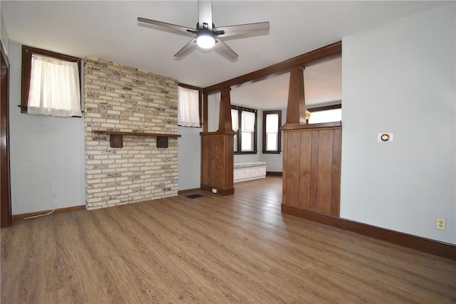 unfurnished living room featuring hardwood / wood-style flooring and ceiling fan