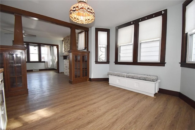 interior space with ceiling fan and wood-type flooring