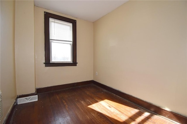 empty room with dark wood-type flooring