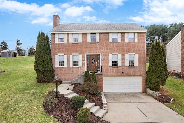 colonial-style house featuring a front yard and a garage