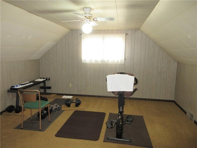 exercise area featuring vaulted ceiling, light colored carpet, and ceiling fan