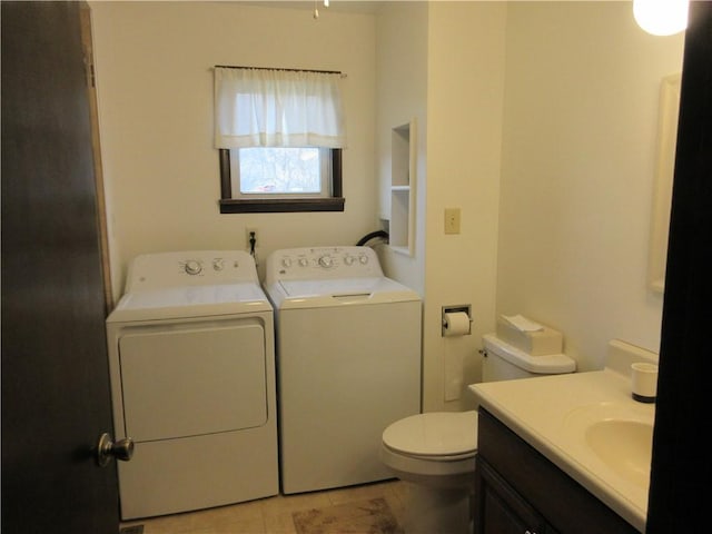 bathroom with independent washer and dryer, vanity, and toilet