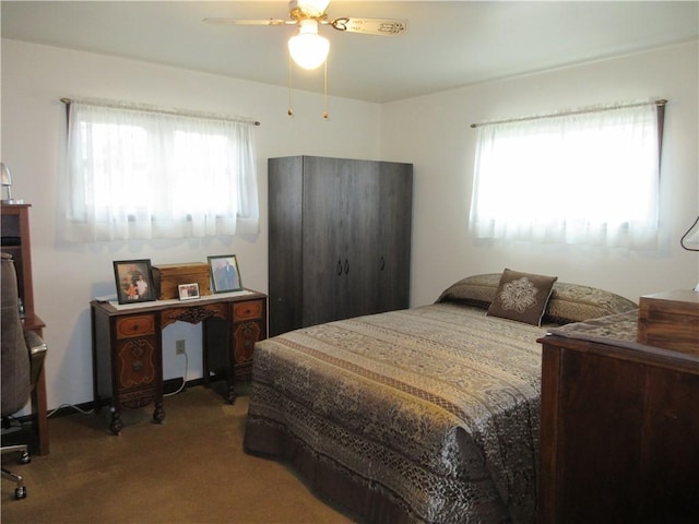 bedroom featuring ceiling fan, carpet, and multiple windows