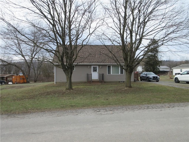 single story home featuring a front lawn