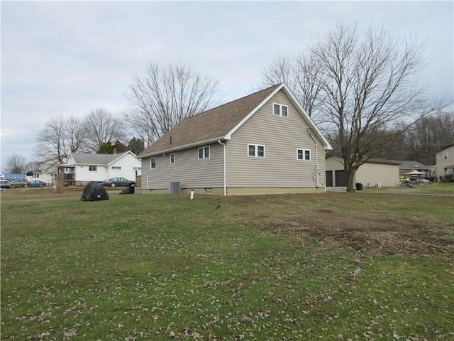 view of home's exterior with central air condition unit and a yard