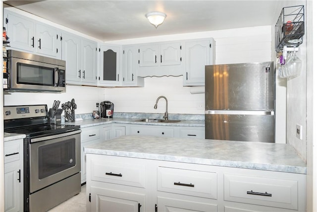 216 Karen Dr, Allegheny Twp Wml, PA 15613 - kitchen featuring white cabinets, stainless steel appliances, light countertops, light tile patterned floors, and a sink