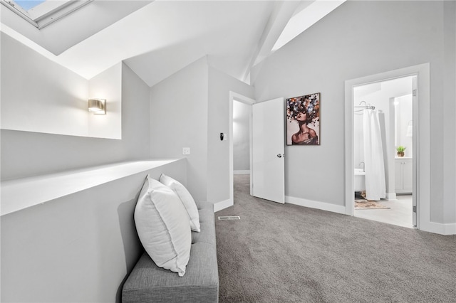 bathroom featuring lofted ceiling with skylight