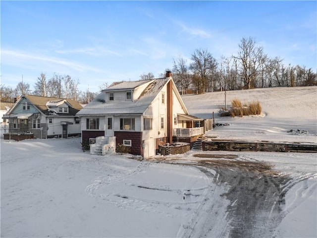 view of snow covered back of property