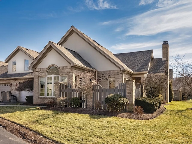 view of front of home with a garage and a front lawn