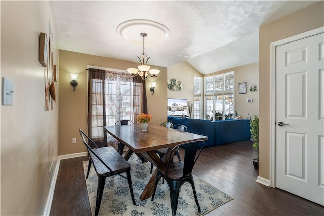 dining space featuring vaulted ceiling, dark wood-type flooring, and a chandelier