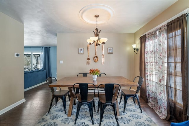 dining area featuring an inviting chandelier and dark hardwood / wood-style flooring