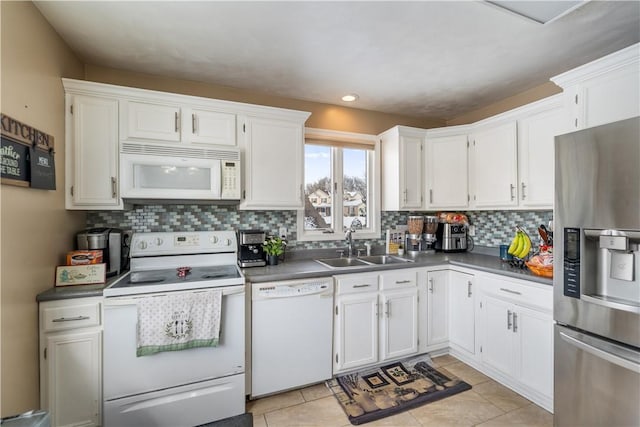 kitchen featuring sink, white appliances, white cabinetry, and tasteful backsplash