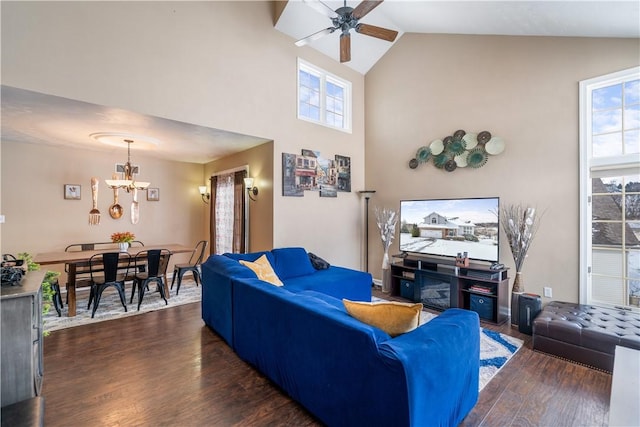 living room featuring high vaulted ceiling, dark hardwood / wood-style floors, and ceiling fan with notable chandelier