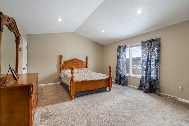 bedroom with lofted ceiling and light colored carpet