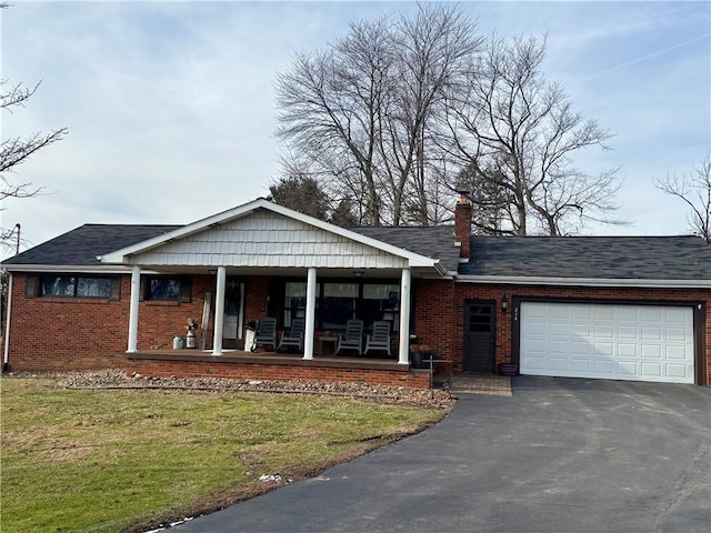 single story home featuring covered porch, a front yard, and a garage