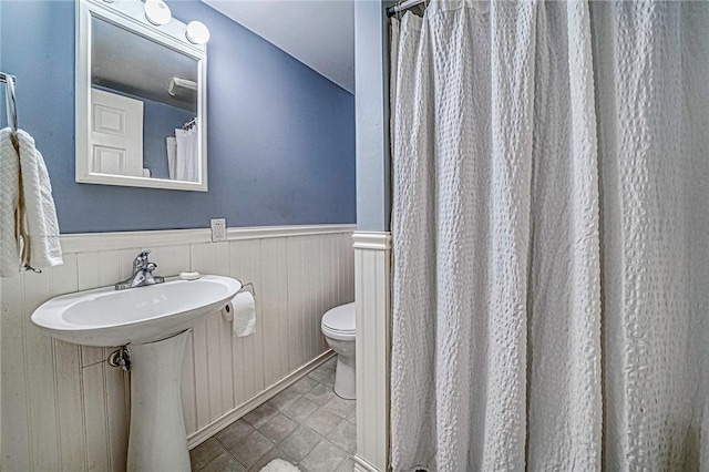 bathroom with sink, toilet, and tile patterned floors