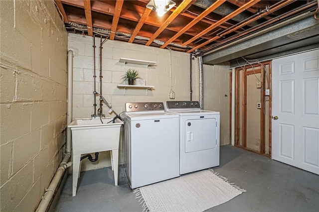 clothes washing area with sink and washer and dryer