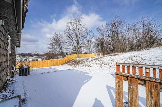 yard layered in snow featuring central AC