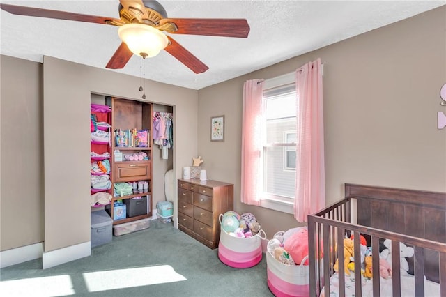 bedroom featuring ceiling fan, carpet floors, and a textured ceiling