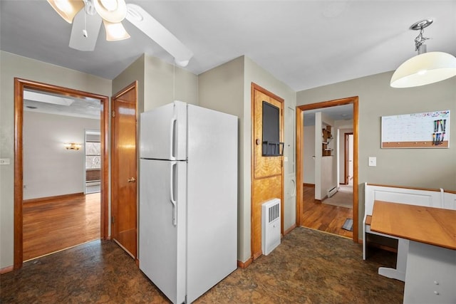 kitchen featuring ceiling fan, hanging light fixtures, white cabinetry, and white refrigerator