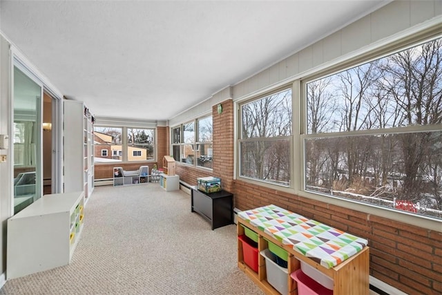 sunroom / solarium featuring a baseboard heating unit