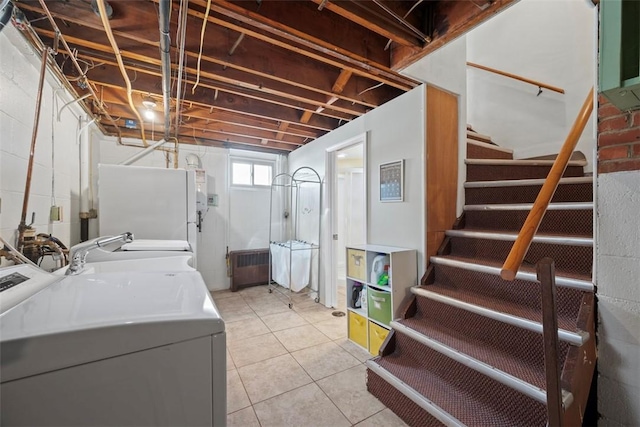 laundry room with washing machine and dryer and light tile patterned flooring