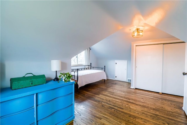 unfurnished bedroom featuring lofted ceiling and dark hardwood / wood-style floors