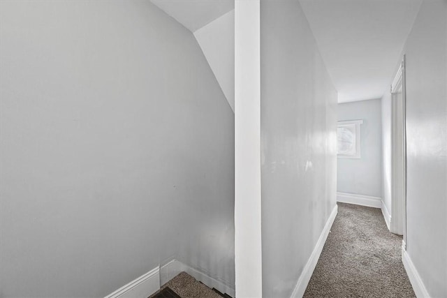 corridor with dark colored carpet