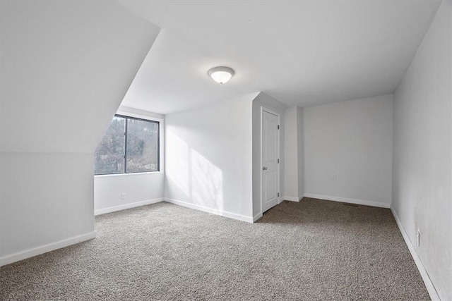 additional living space with carpet floors and lofted ceiling