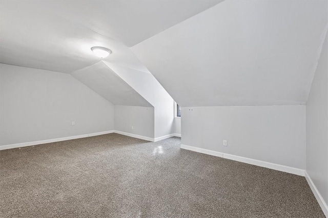 bonus room featuring vaulted ceiling and carpet flooring