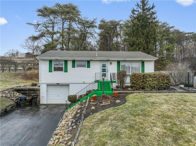 ranch-style house with a garage, driveway, and a front lawn