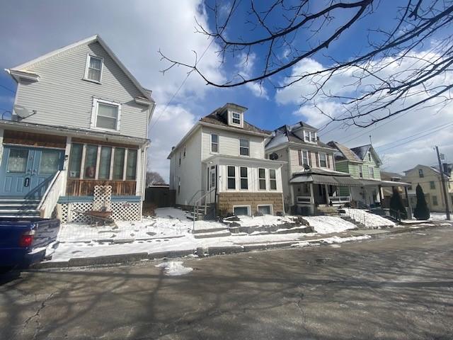 view of snow covered rear of property