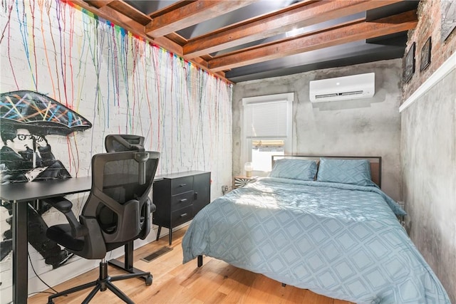 bedroom with hardwood / wood-style floors and a wall mounted air conditioner