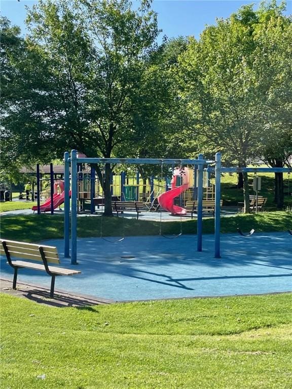 view of property's community with a lawn and playground community