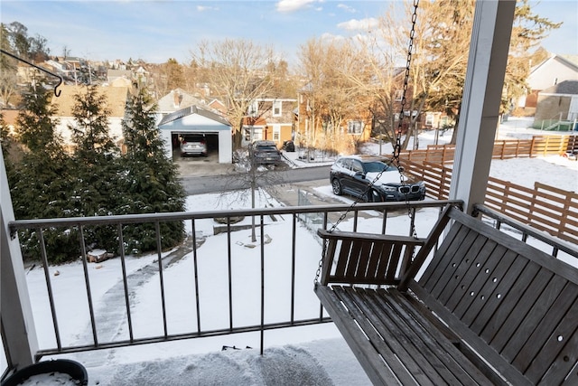 snow covered back of property with a residential view