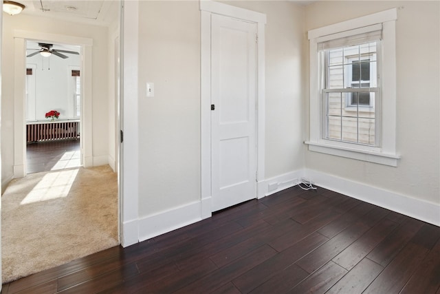 interior space with dark wood-type flooring and baseboards