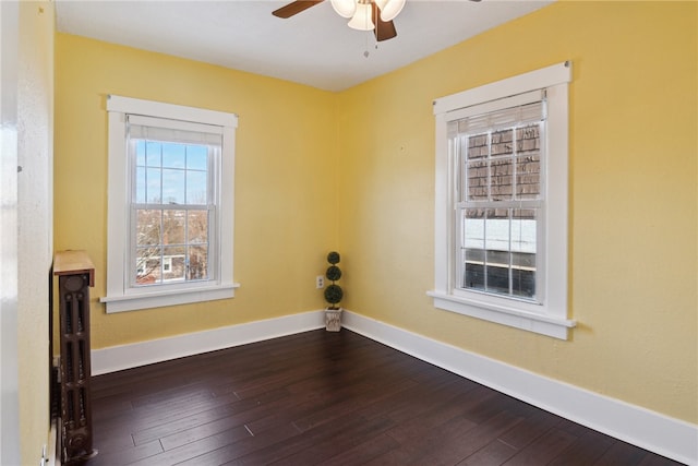 spare room with wood-type flooring, baseboards, and ceiling fan